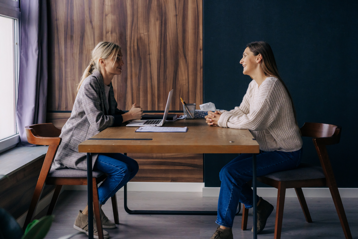 Two colleagues in a workplace wellbeing meeting